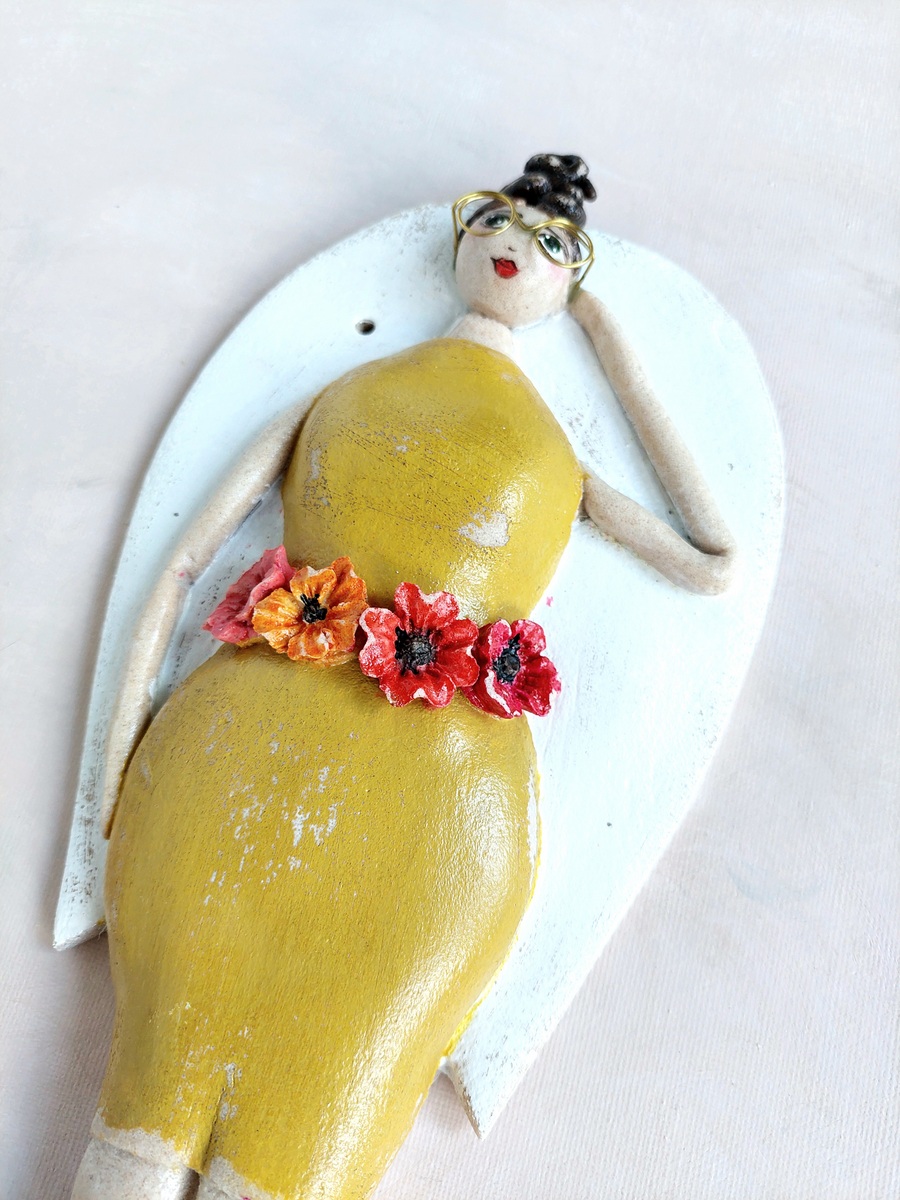 Anioł w okularach i żółtej sukience dla kobiety z klasą